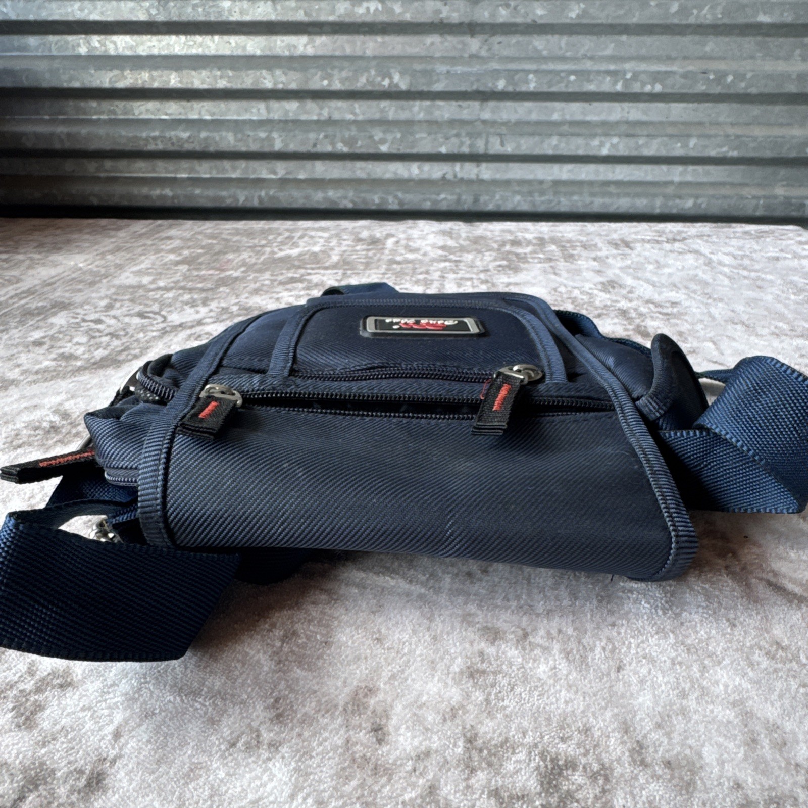Lu Dong Hao branded small backpack featuring zippered compartments.