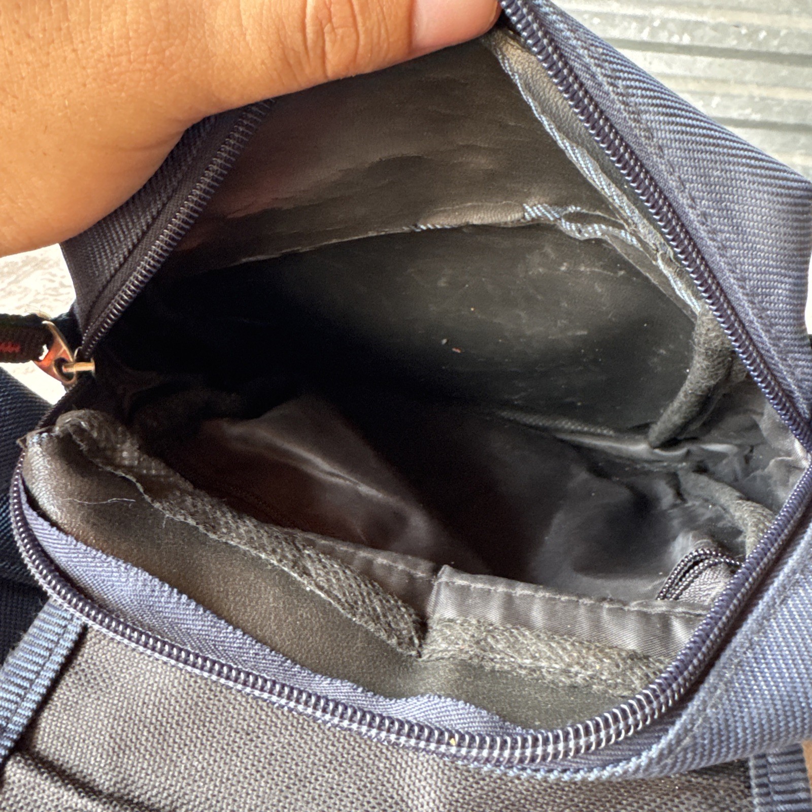 Lu Dong Hao branded small backpack featuring zippered compartments.