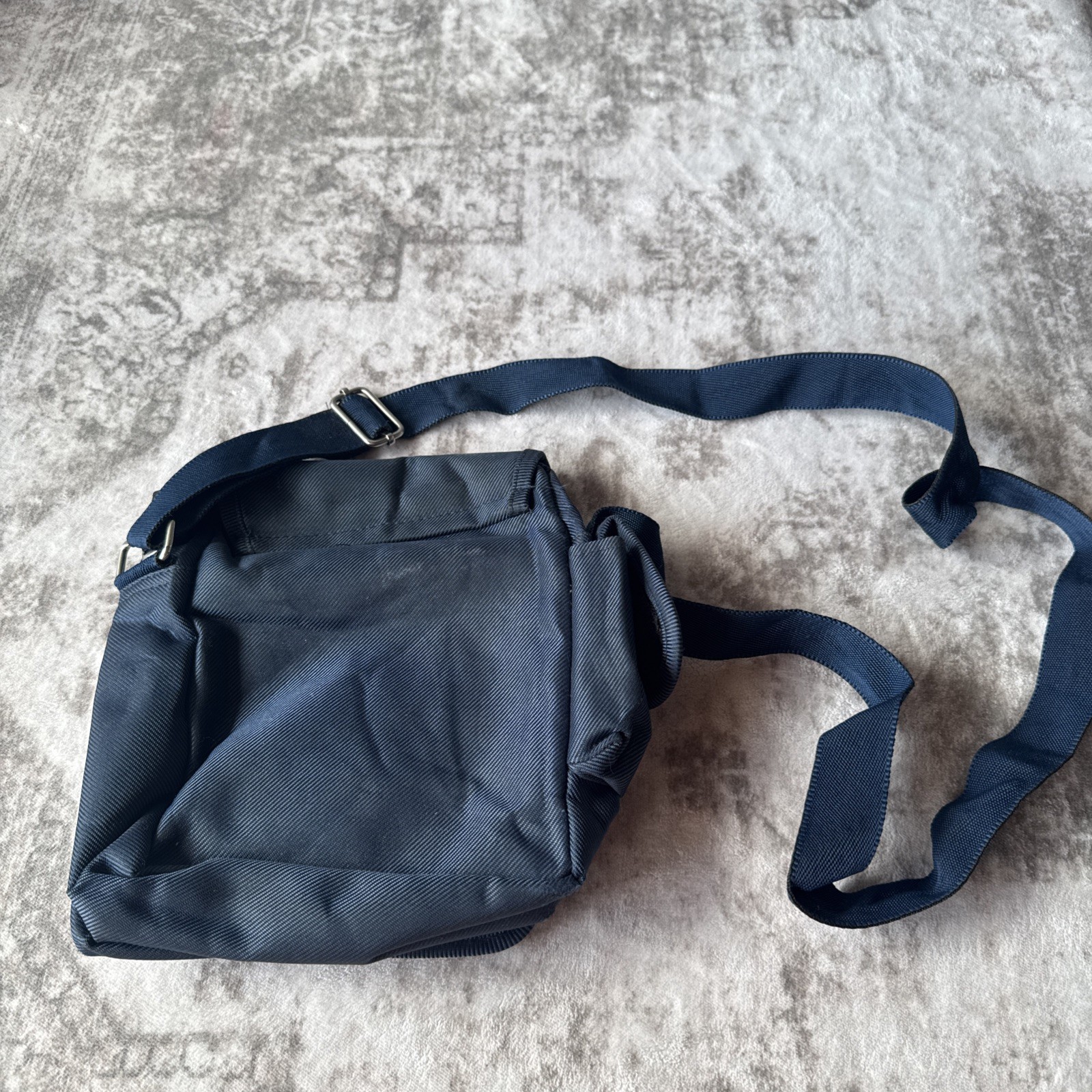 Lu Dong Hao branded small backpack featuring zippered compartments.