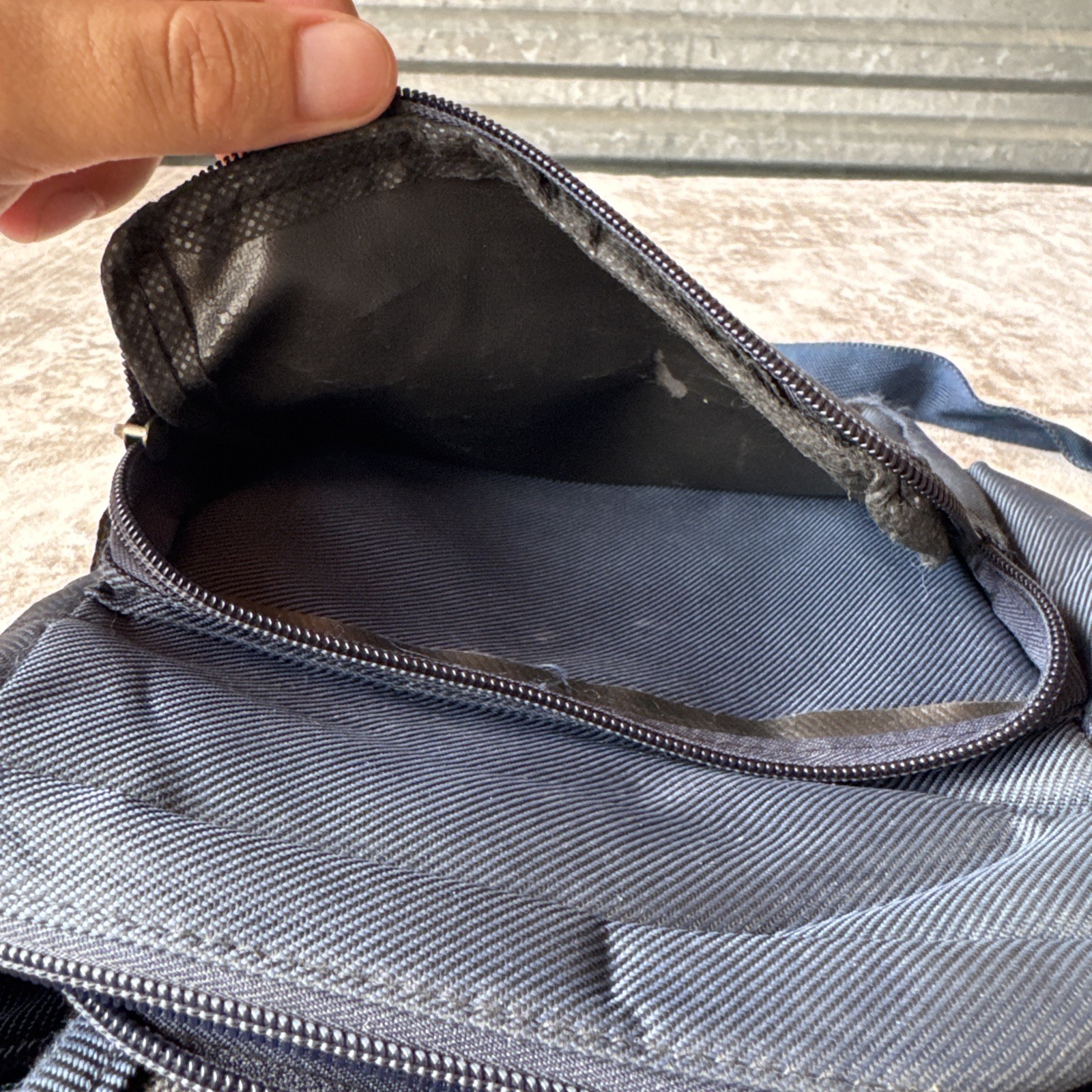 Lu Dong Hao branded small backpack featuring zippered compartments.